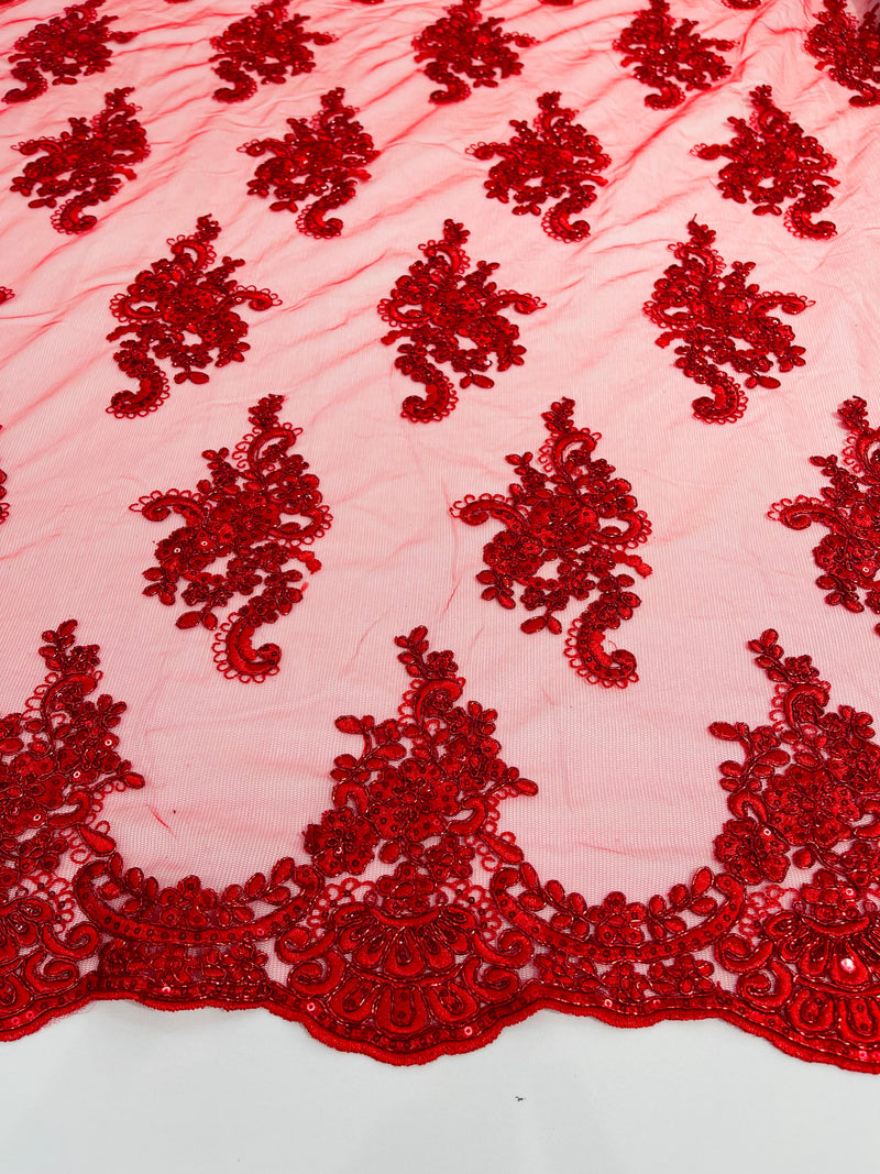 Red metallic floral design embroidery on a mesh lace with sequins and cord-sold by the yard.