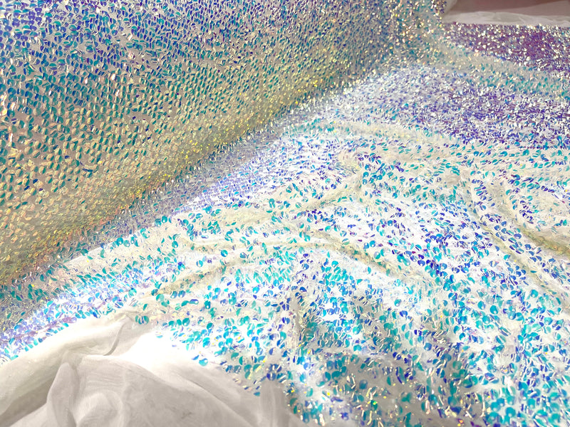 Aqua Clear iridescent mini round paillette sequins on a white stretch mesh, sold by the yard.