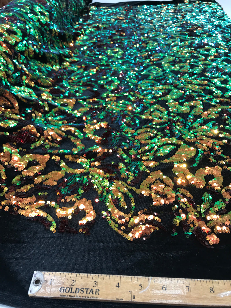 Orange, Green iridescent sequins flip two tone floral design on a black stretch velvet, Sold by the yard.