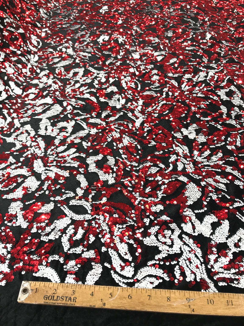 Red, white sequins flip two tone floral design on a black stretch velvet, Sold by the yard.