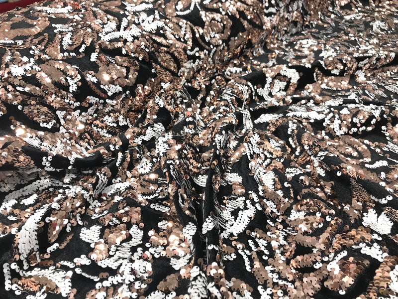 Rose gold, white sequins flip two tone floral design on a black stretch velvet, Sold by the yard.