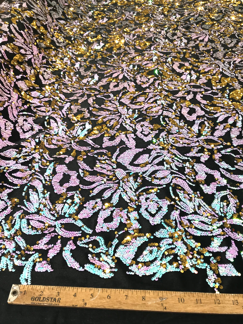 Aqua iridescent ,pink, gold  sequins flip two tone floral design on a black stretch velvet, Sold by the yard.